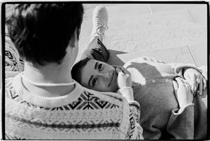Salt lake city film photoshoot of couple sitting and looking at eachother at city hall