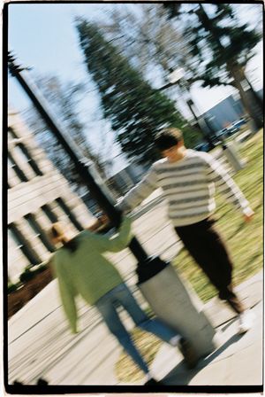 Salt lake city film photoshoot of couple running around lightpost at city hall