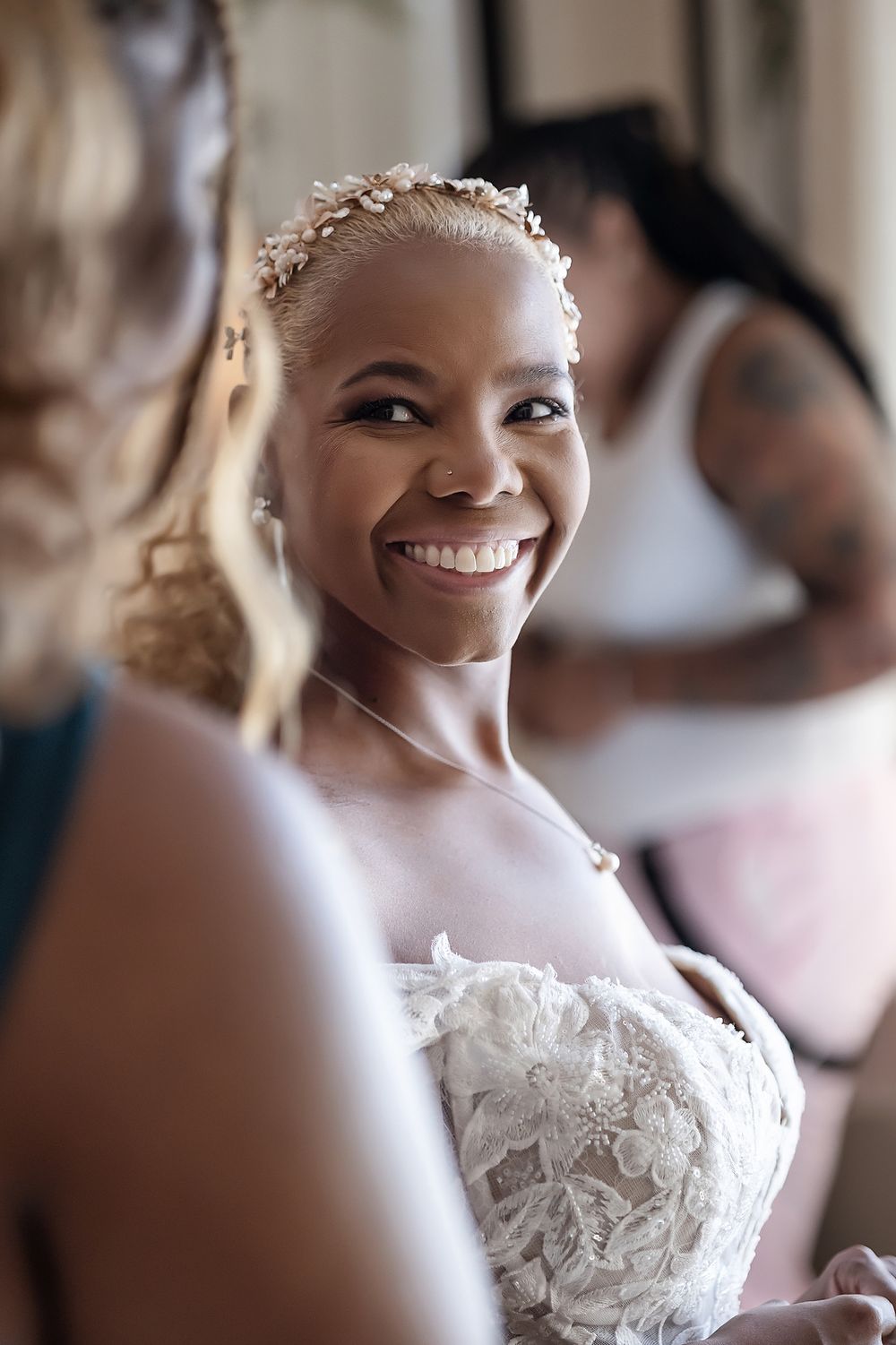 Bride Cherese with her bridesmaid adjusting the veil before the ceremony.