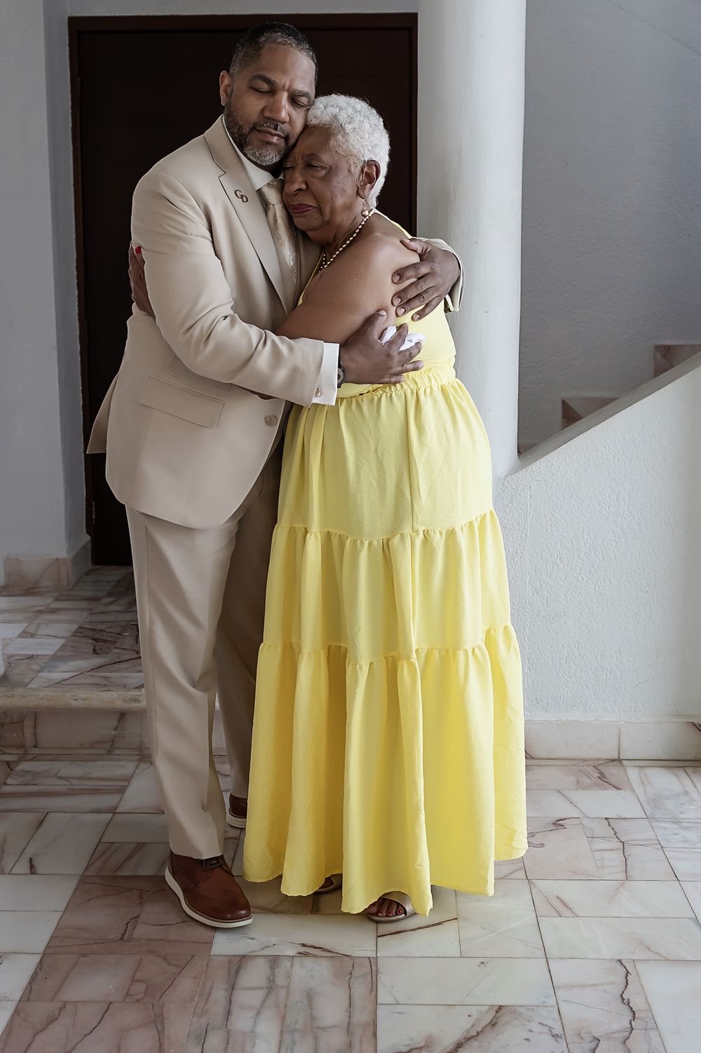 Groom embracing his mother during emotional first look.