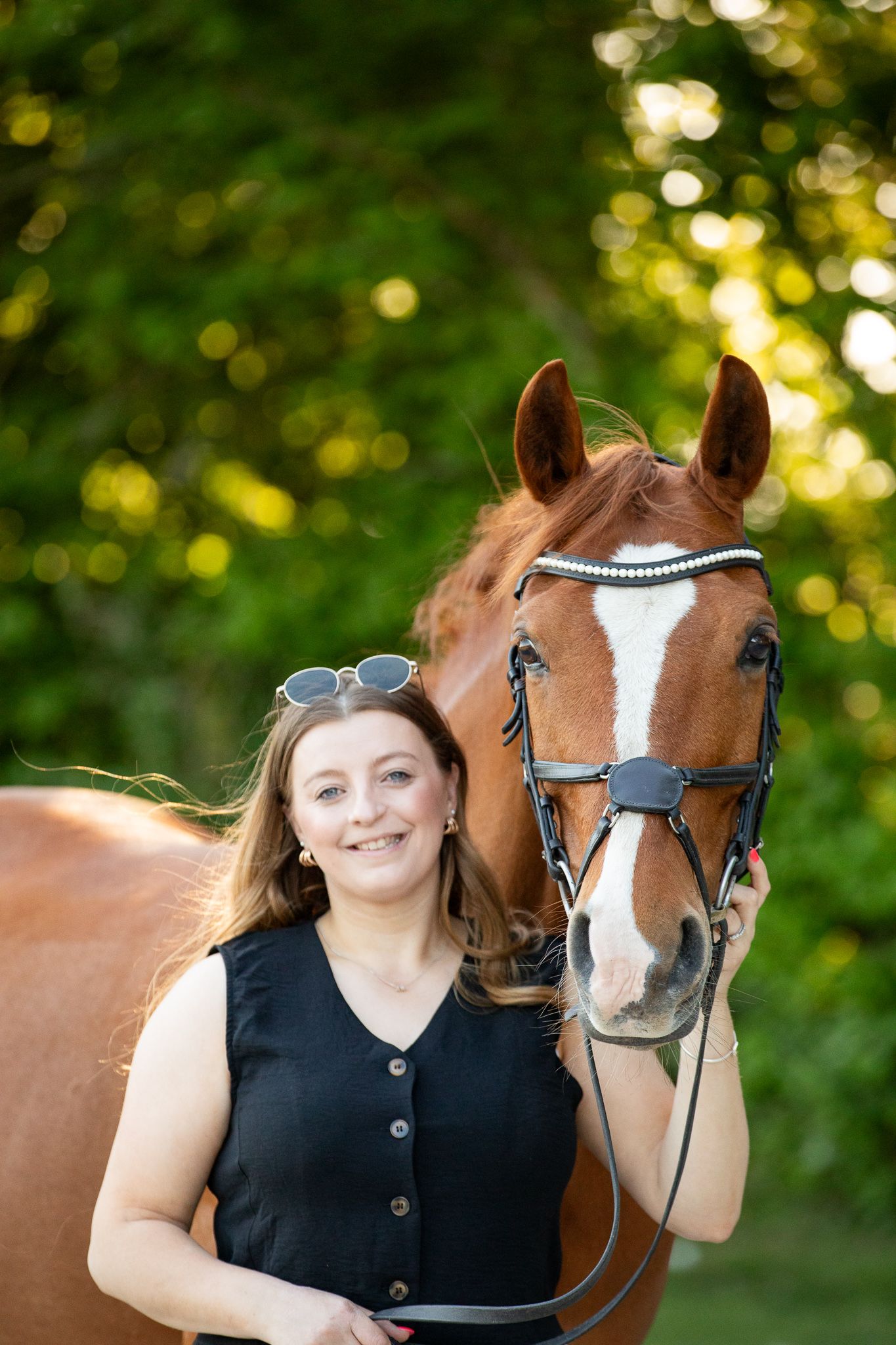 Young equestrian poses with palomino pony in a series of natural outdoor portraits showing their special bond.