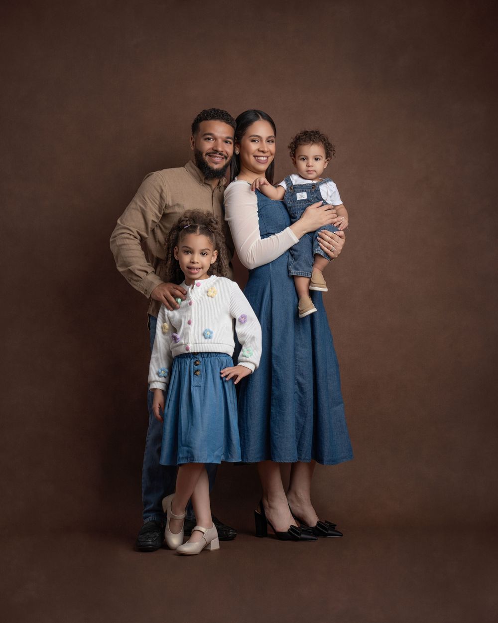 Professional studio portrait montage of a family in coordinated denim and beige outfits against a warm brown backdrop.