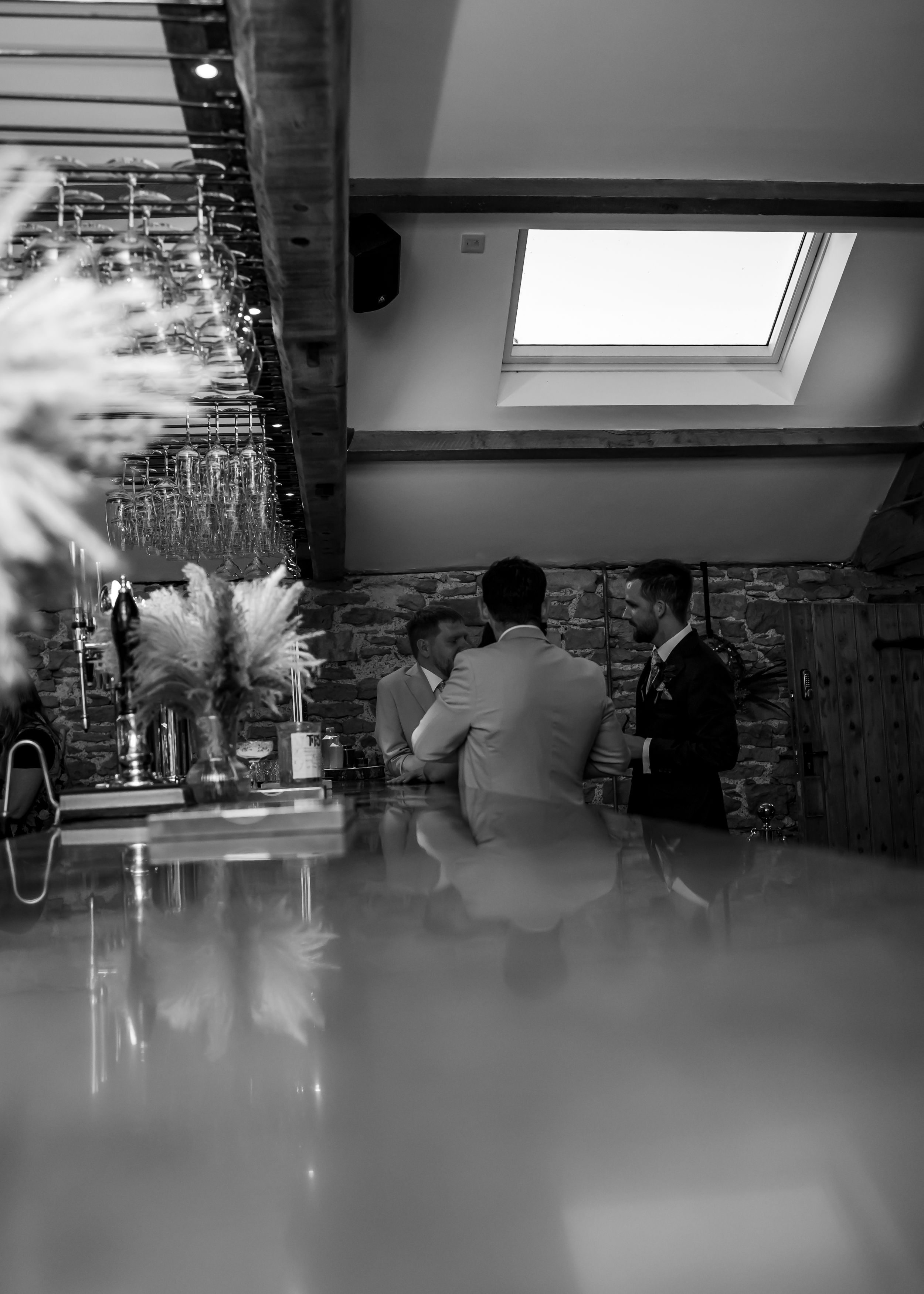 non-traditional wedding photographer in the Lake District- groomsmen having a drink