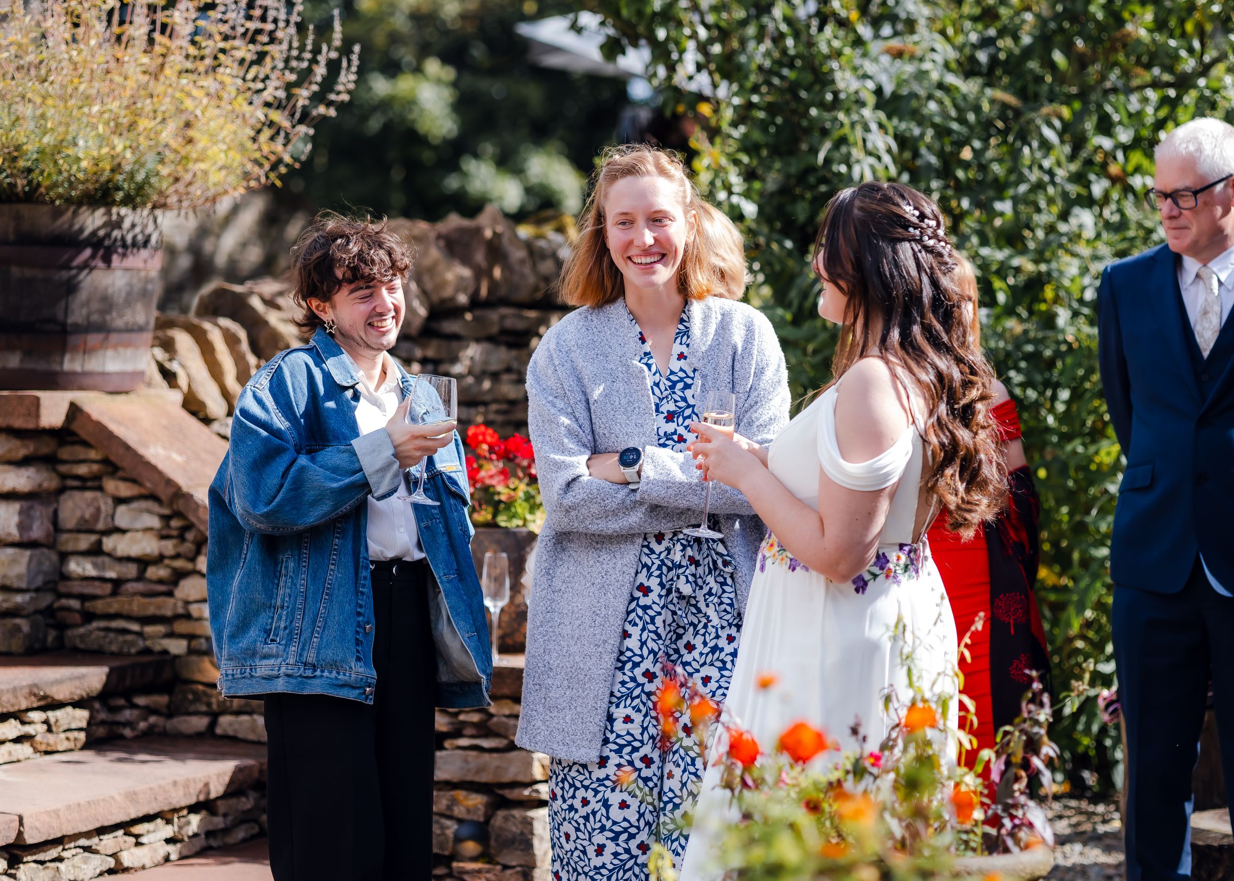 non-traditional wedding photographer in the Lake District - bride laughing with friends
