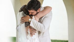 A couple embraces intimately during an emotional moment at their wedding ceremony.
