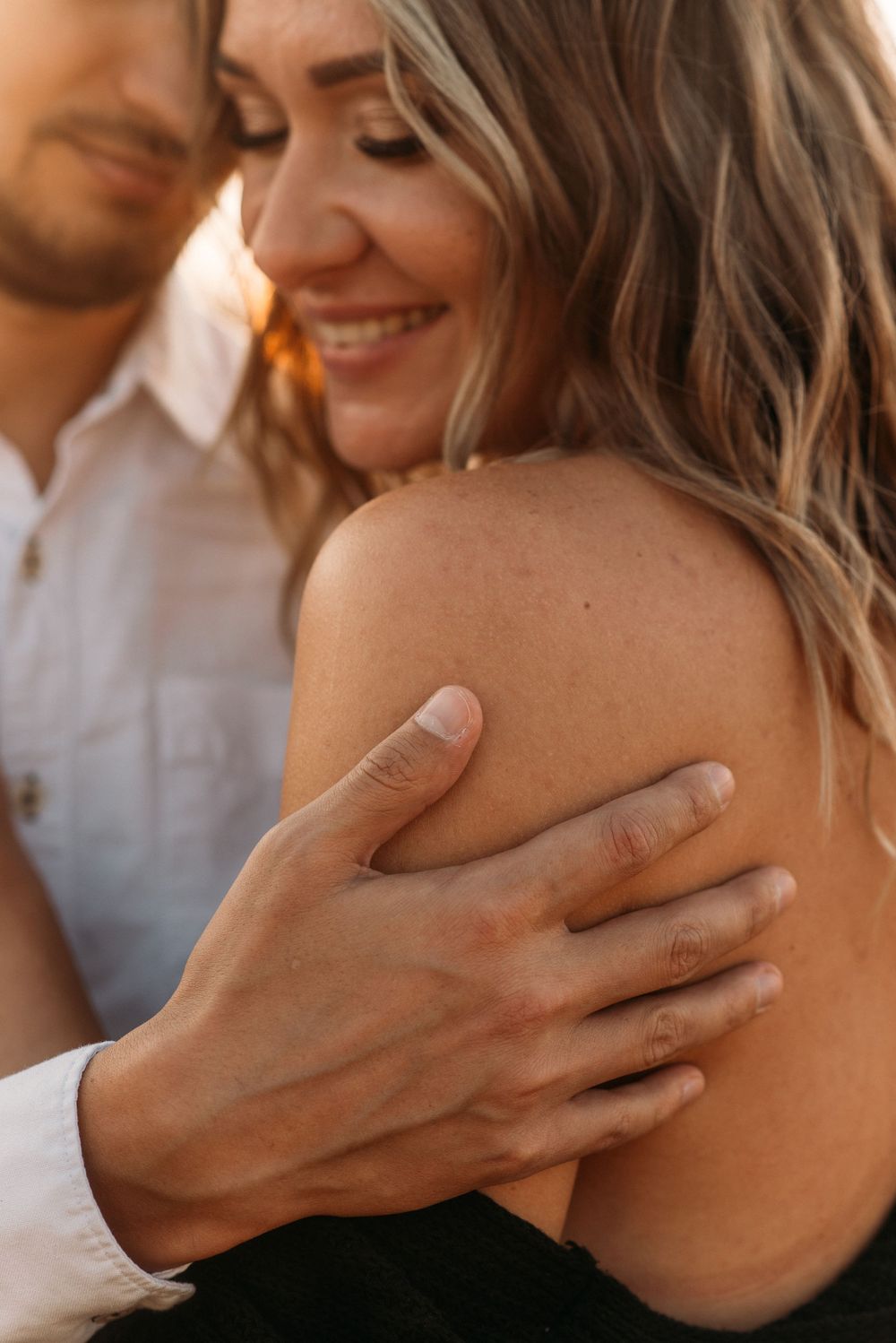 Intimate close-up shots focusing on gentle hand placement on shoulder.