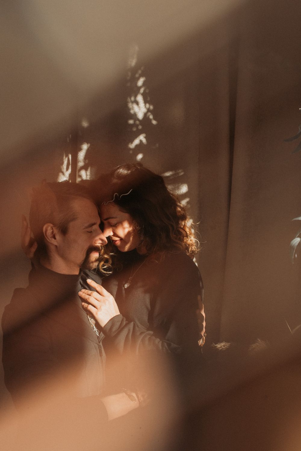 Dreamy sepia-toned romantic portraits with floating bokeh light effects.
