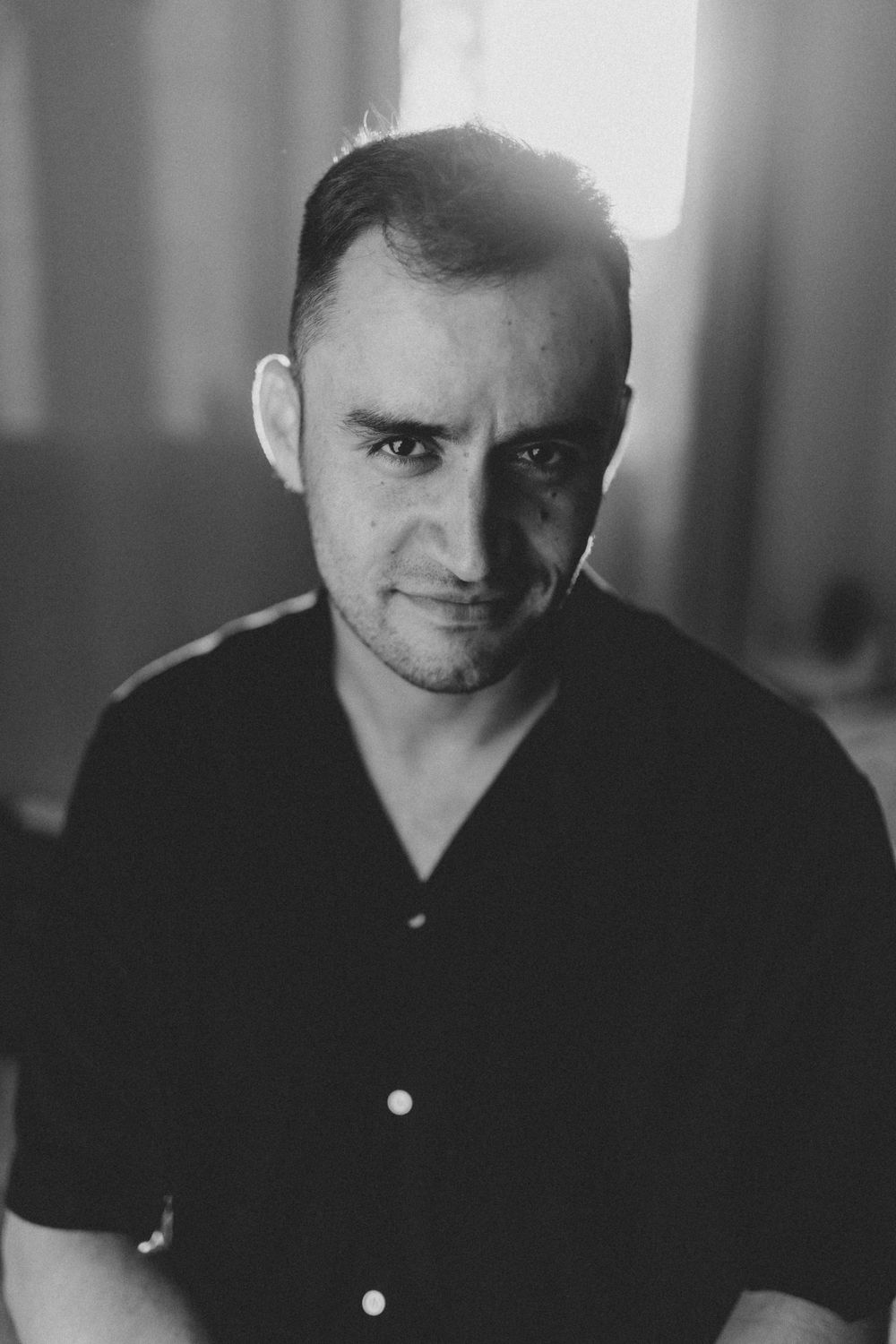 Black and white portrait series showing four different expressions and moods in dramatic lighting.