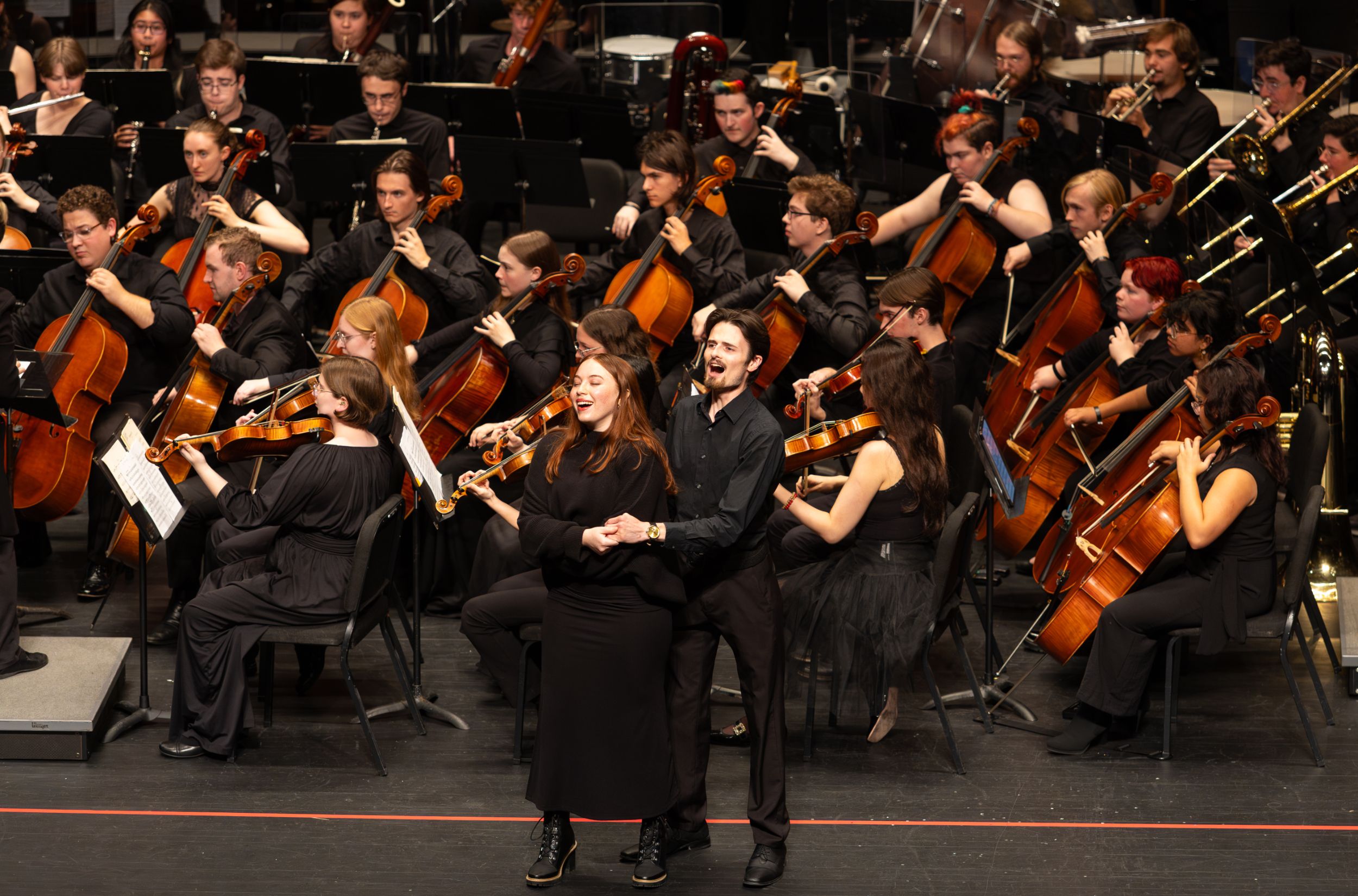 Opera singers perform on stage.