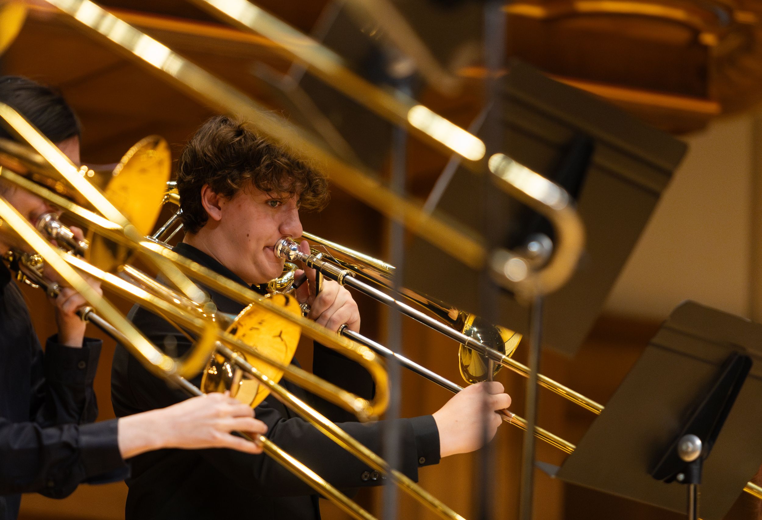 A trombonist performs on stage.