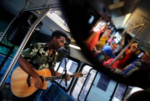 A musician performs on a moving bus.