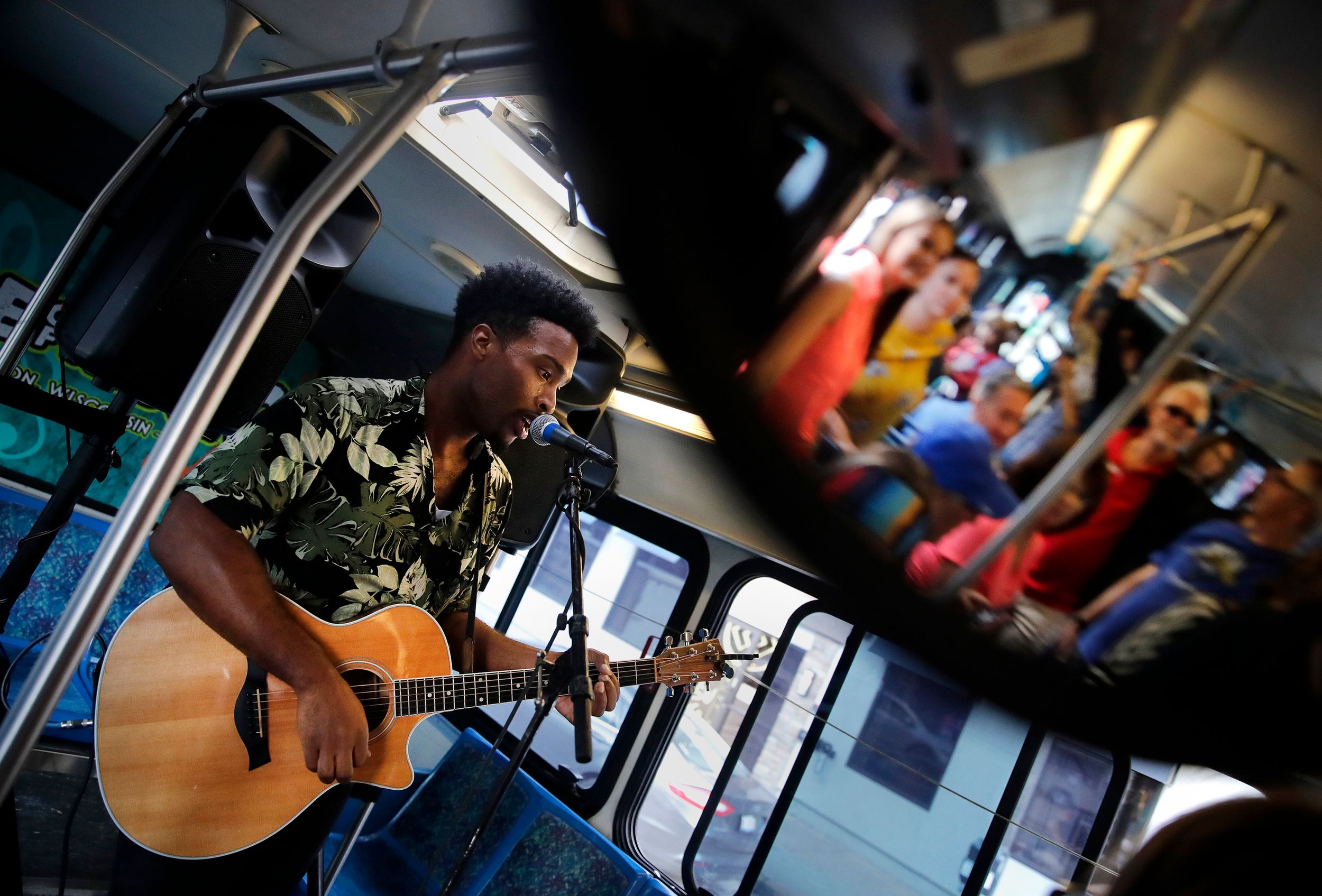 A musician performs on a moving bus.