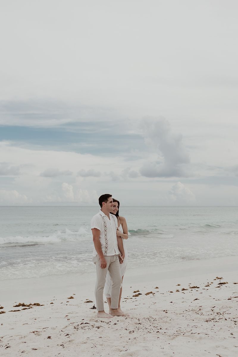 Romantic engagement photoshoot by the turquoise sea at Playa Xpu Ha, Riviera Maya.