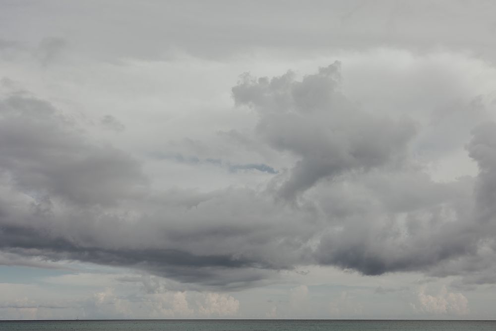 Cloudy Caribbean sky over Playa Xpu Ha during an engagement photoshoot.