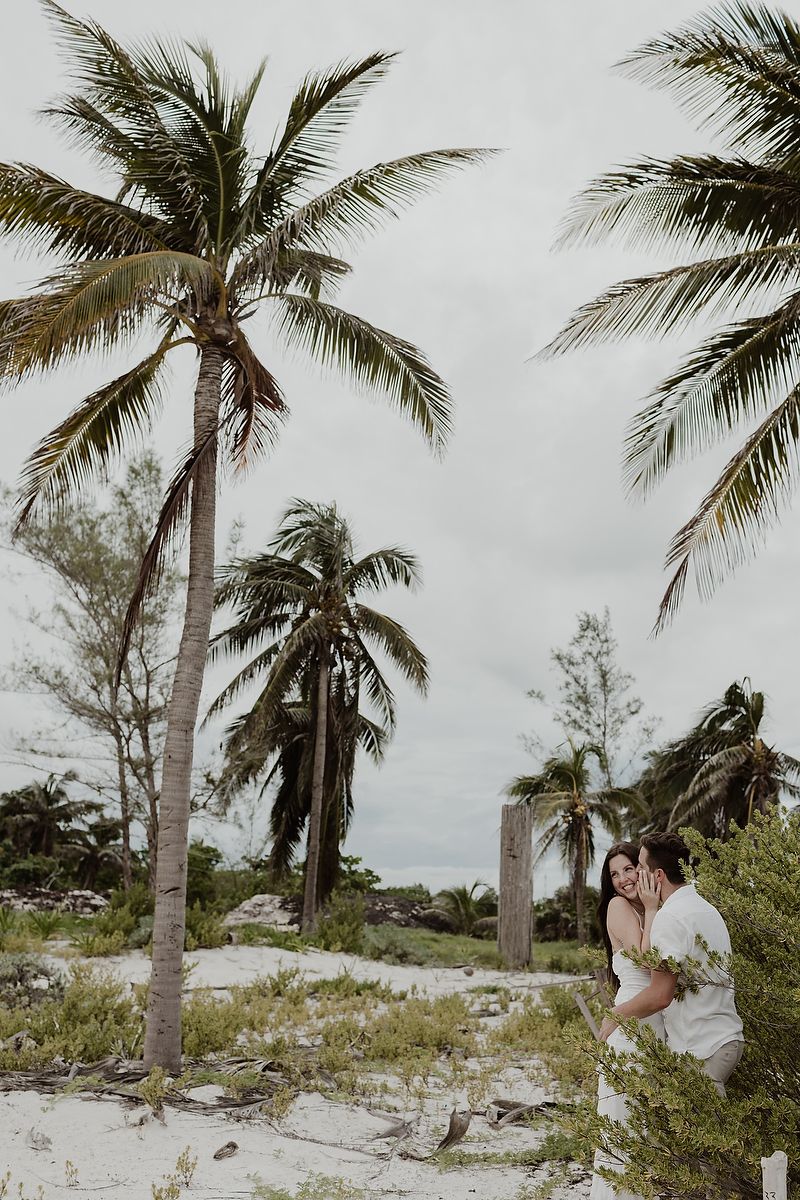 Romantic engagement session surrounded by palm trees at Playa Xpu Ha.