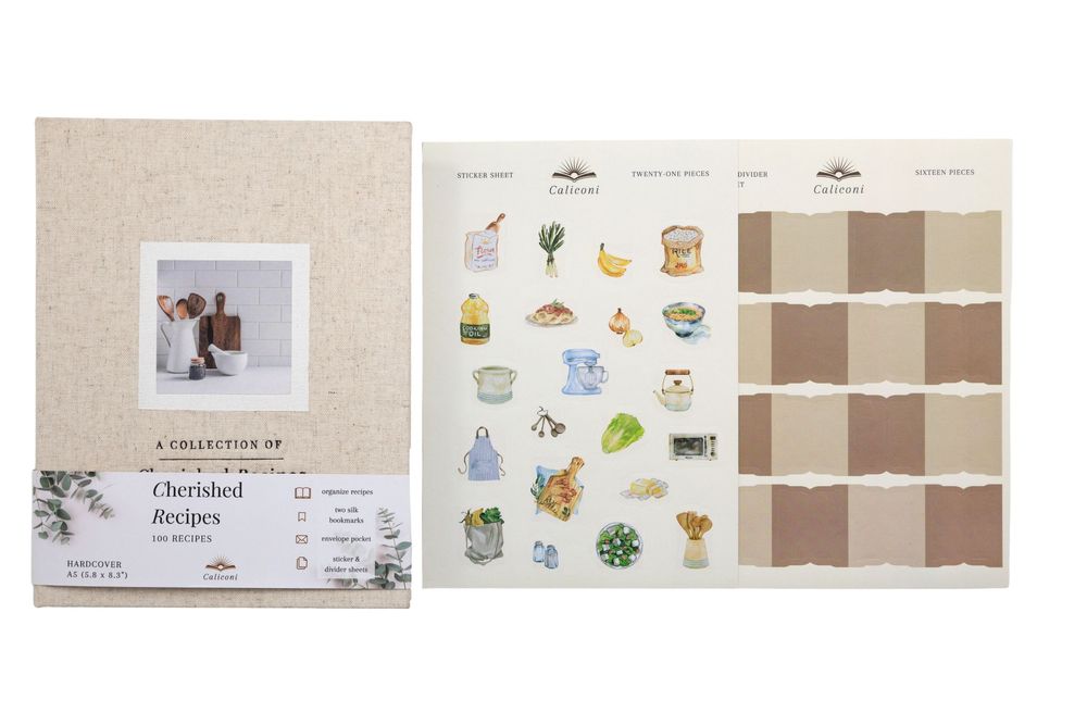 Cherished Recipes journal kit with linen cover, sticker sheet, and recipe cards laid flat.