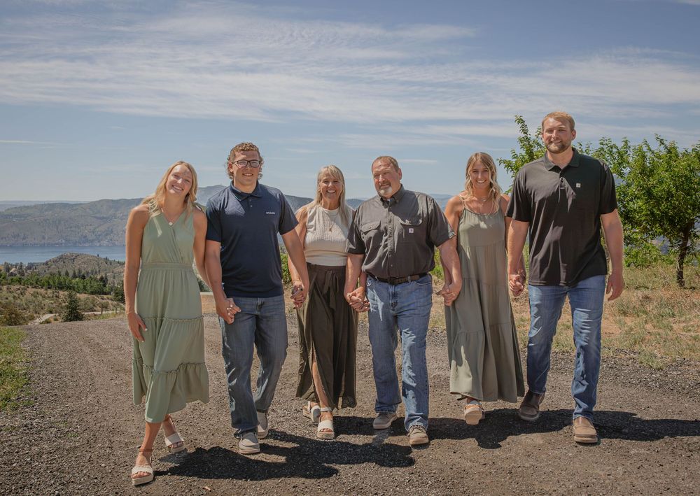 Group walking together on a mountain path with scenic valley views in the background.
