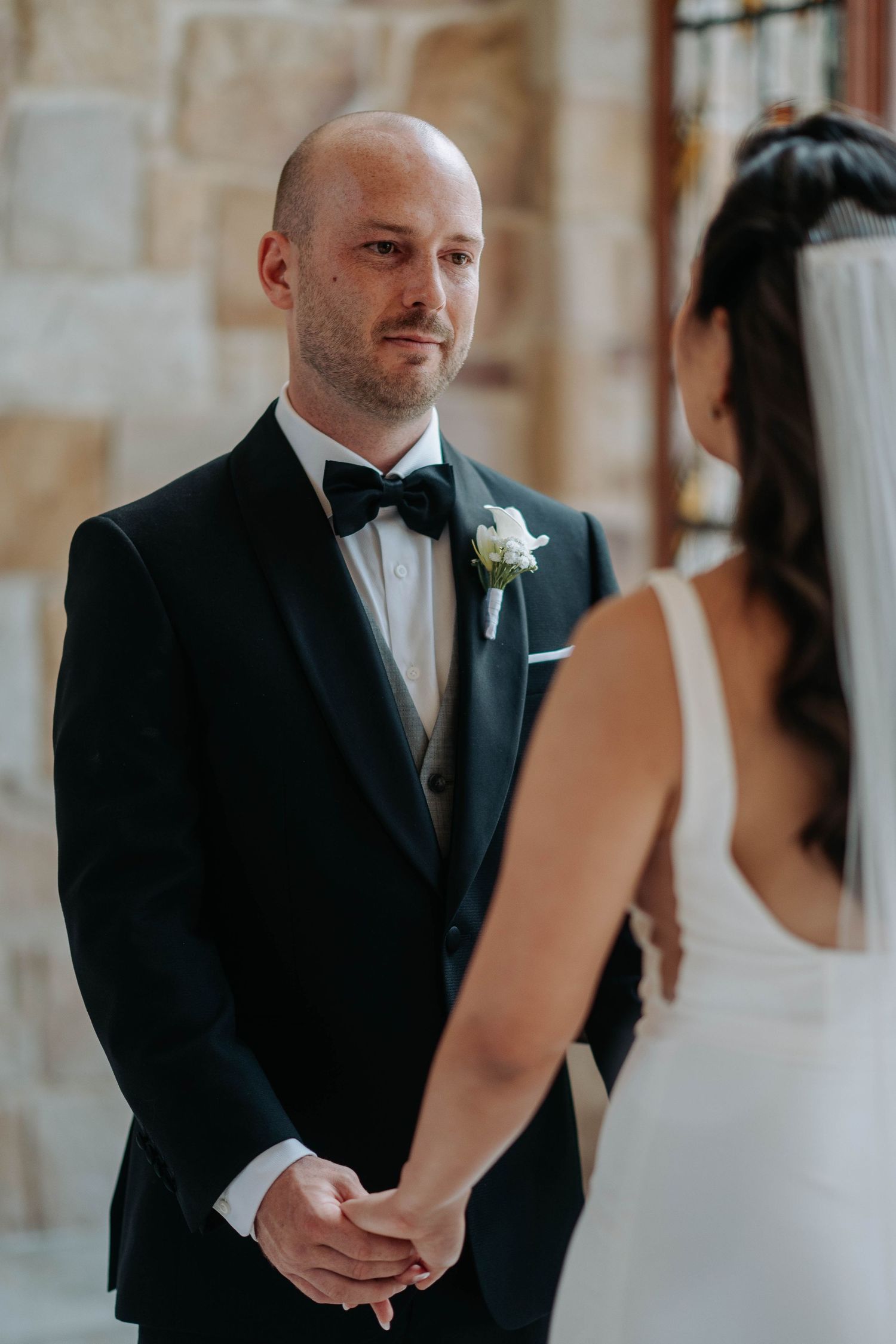 Candid moments from a wedding ceremony showing emotional interactions between the bride and groom.