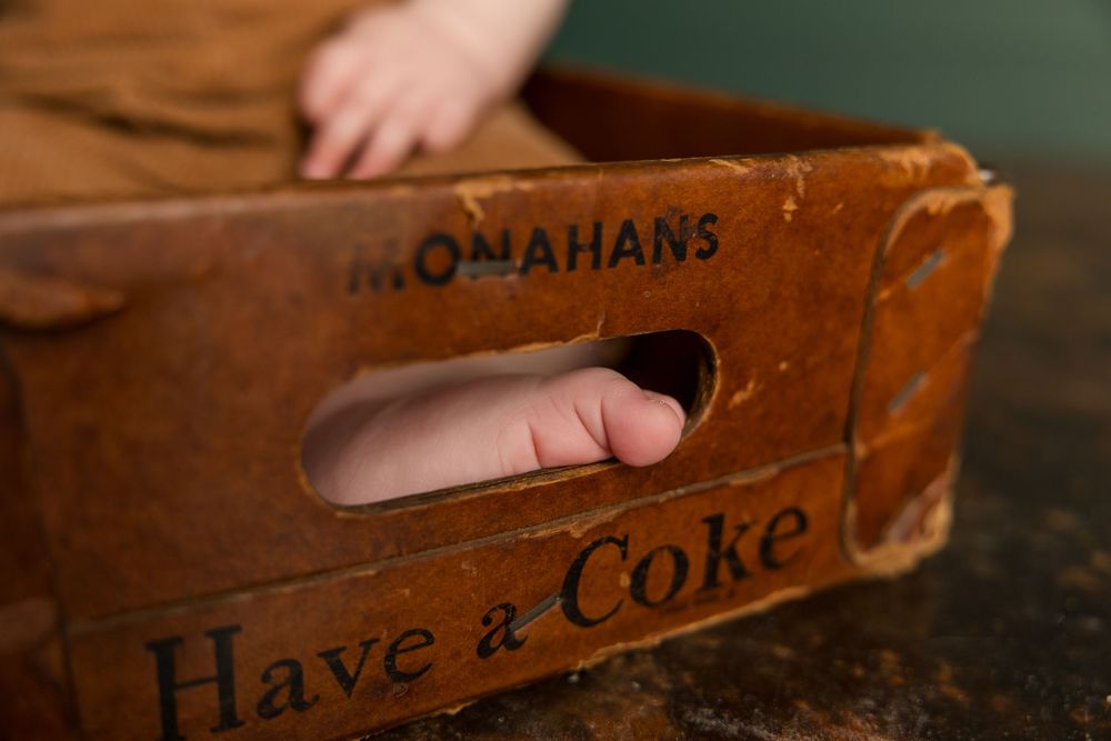 Row of antique wooden Coca-Cola crates showing weathered text and classic branding.