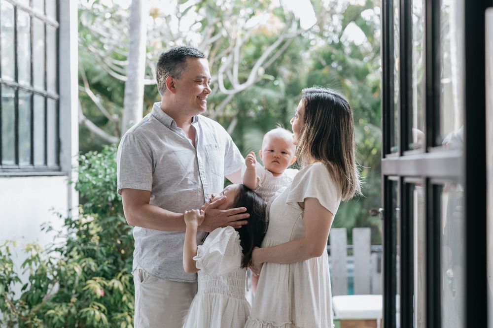 A family shares tender moments in a bright, modern home setting.
