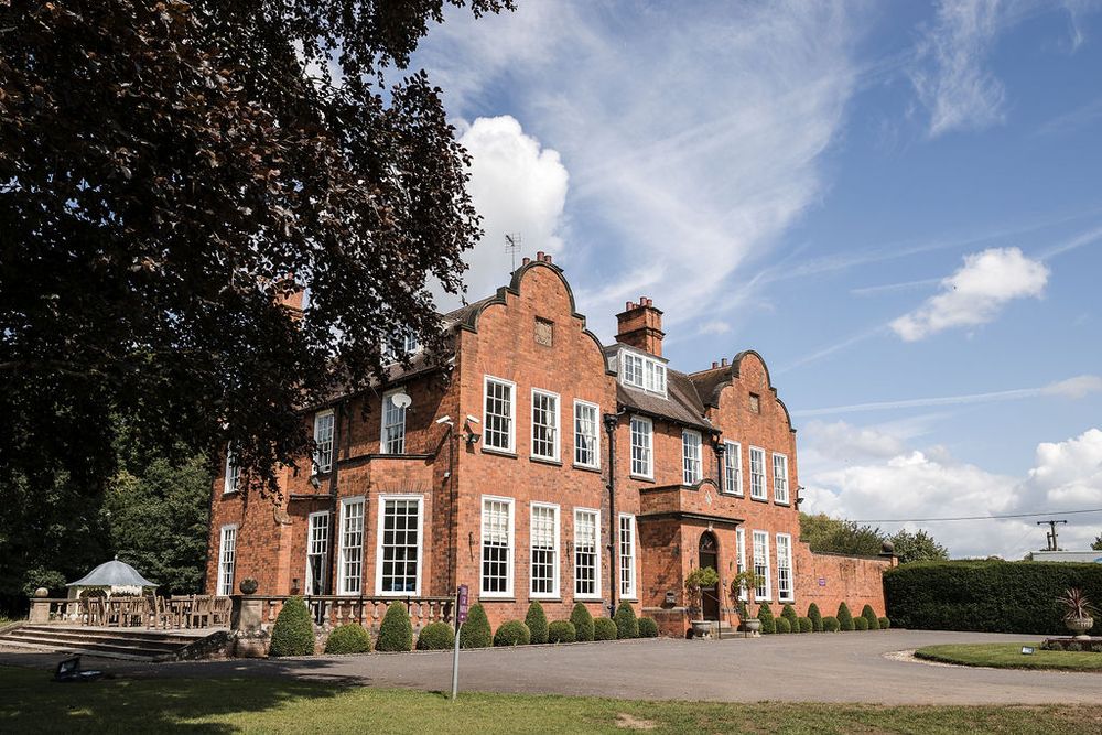 Kelham House historic red-brick manor with large windows and Edwardian architectural features under blue skies