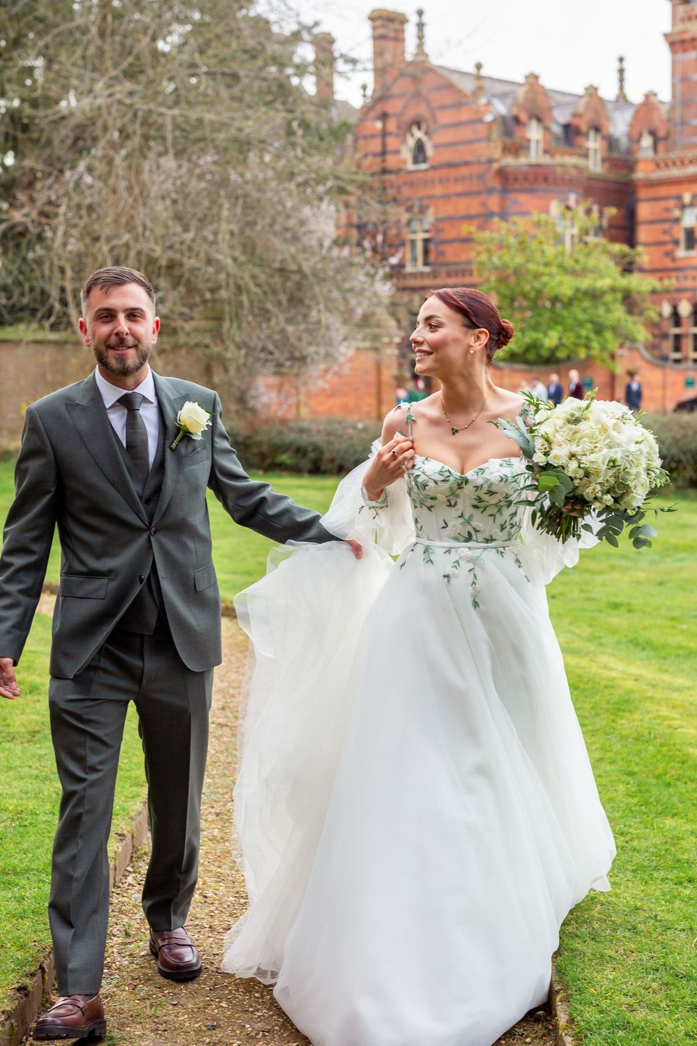 A couple shares joyful moments on their wedding day in front of a brick building, captured in a series of candid shots.