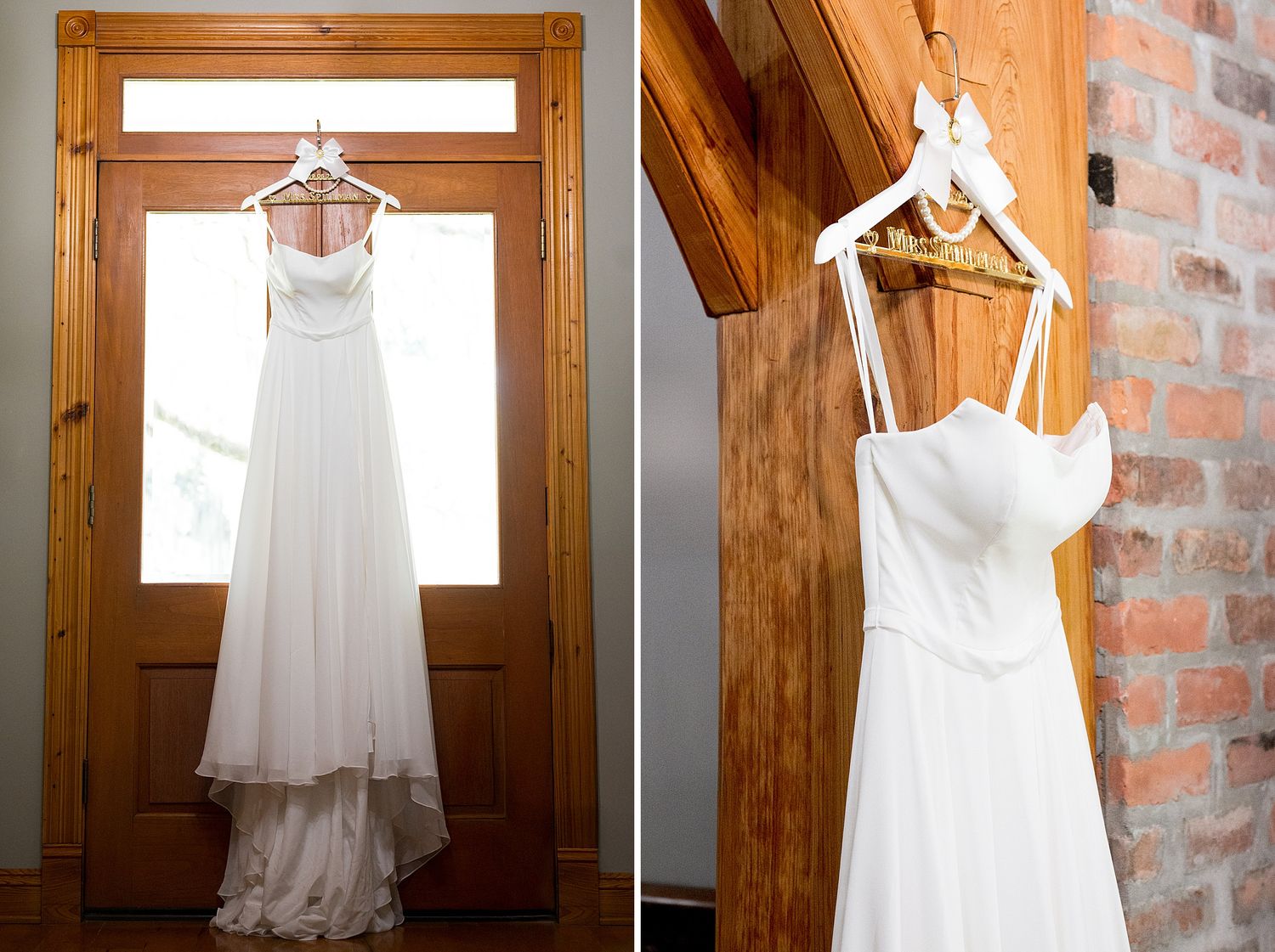 White wedding dress hanging on wooden hangers against exposed brick wall.