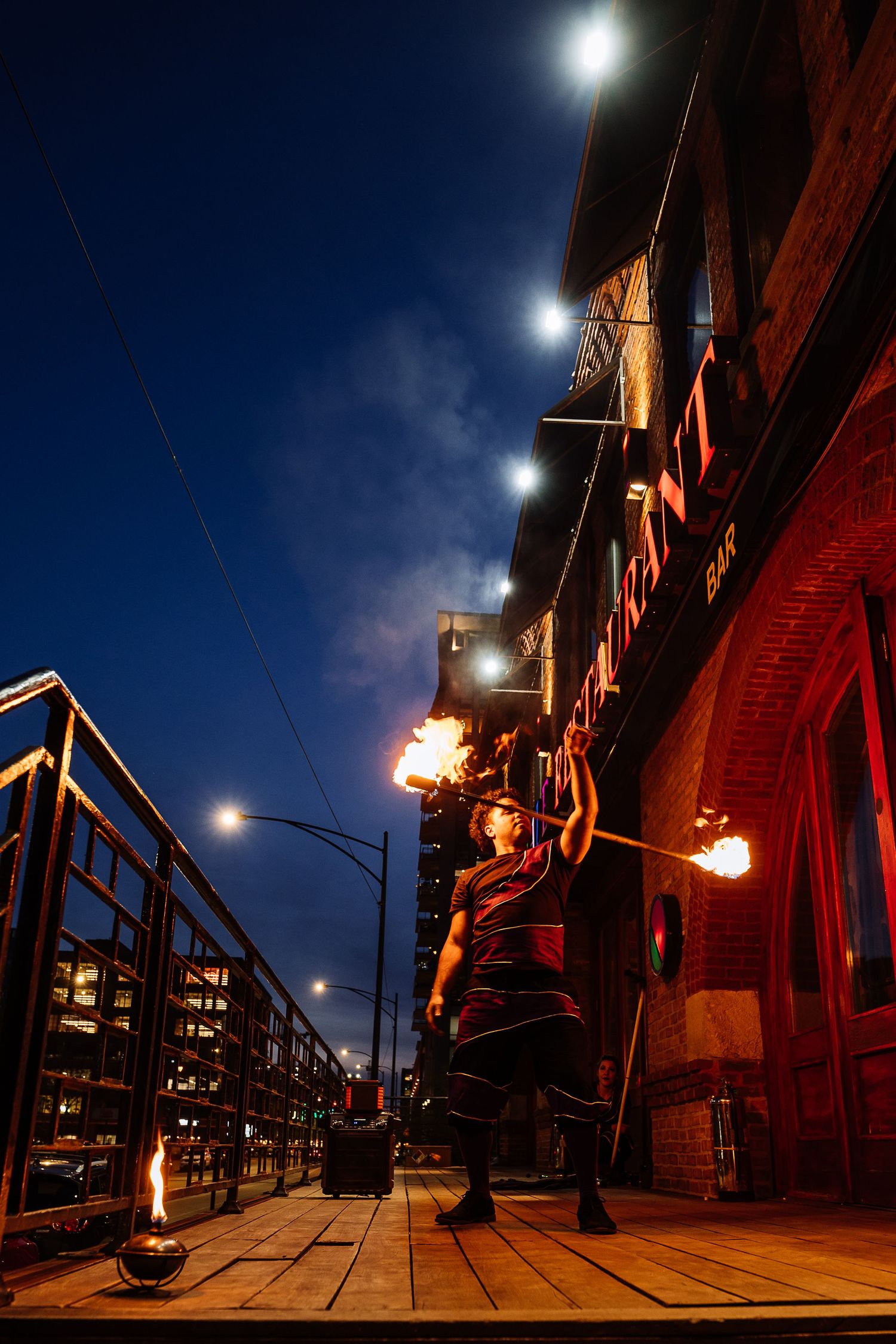 Night scene of brick buildings with vintage street lamps creating dramatic shadows and lighting.