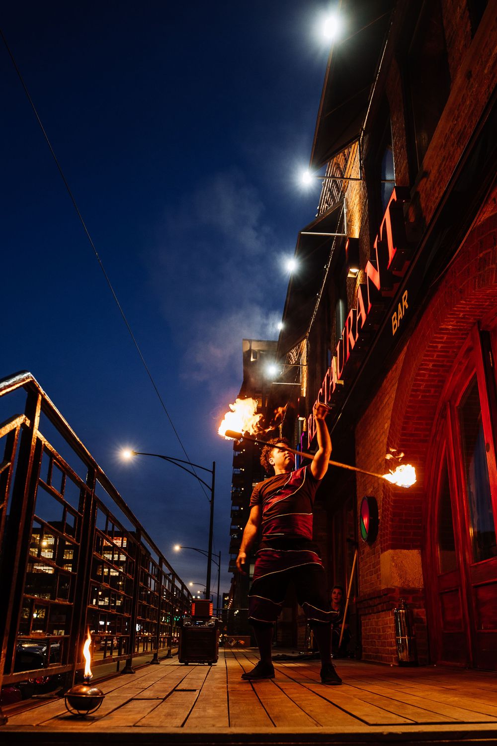 Night scene of brick buildings with vintage street lamps creating dramatic shadows and lighting.