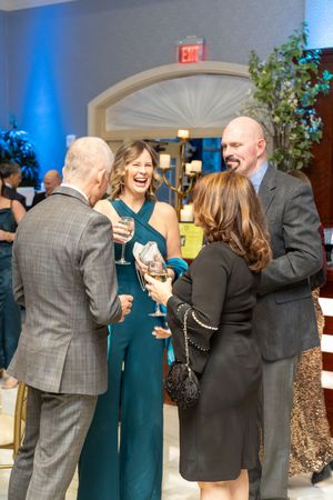 A sequence of candid party photos showing people laughing and socializing at a formal event with blue lighting.