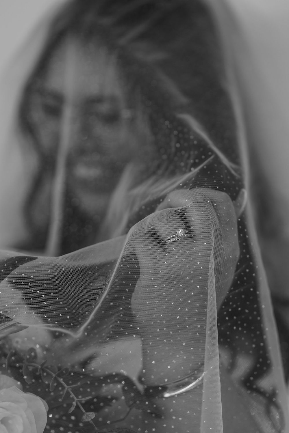 A series of black and white portraits showing someone veiled in translucent fabric with a dreamy, ethereal quality.