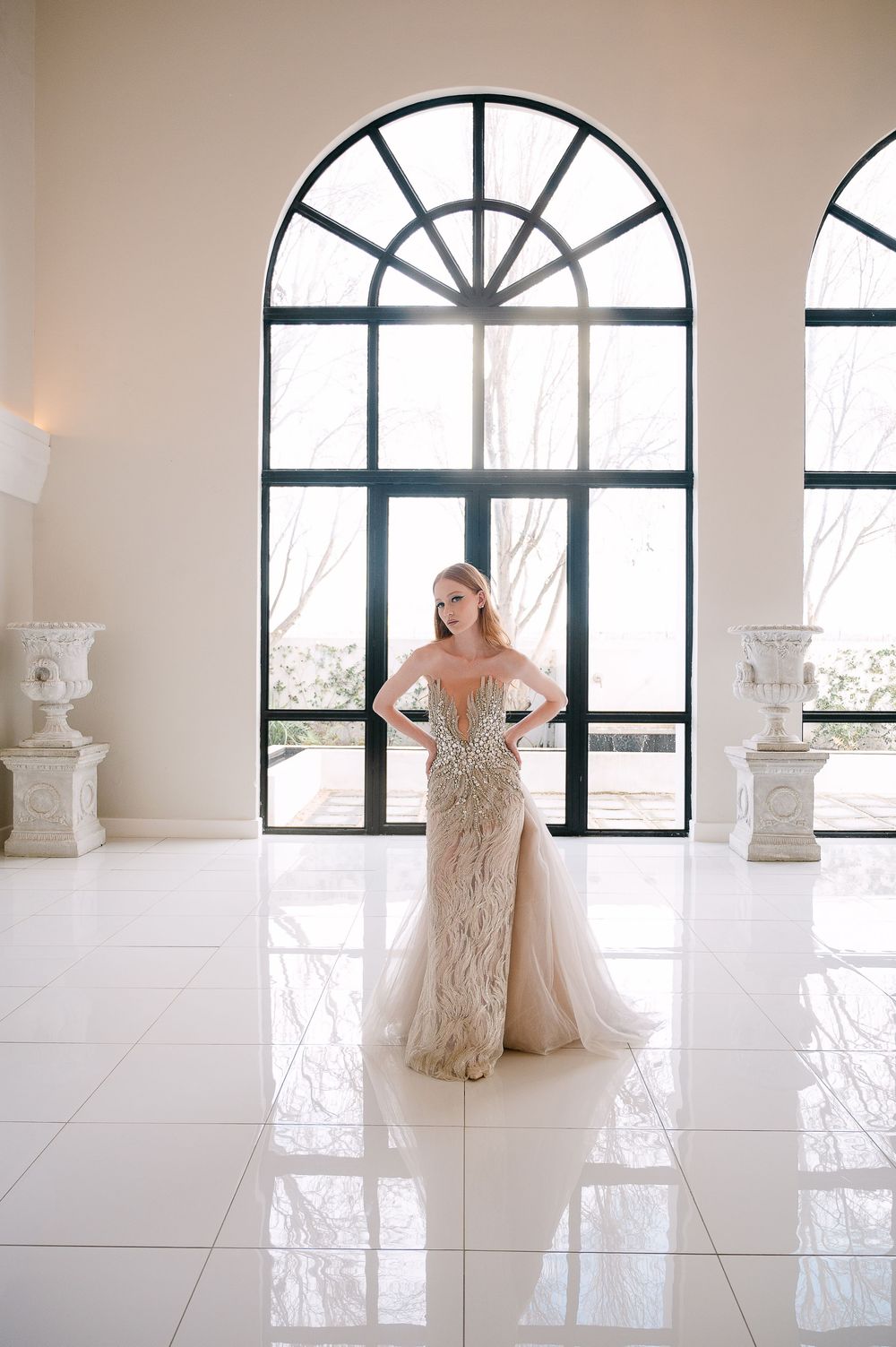 Bridal fashion session featuring a champagne-colored embellished gown in a bright white room.