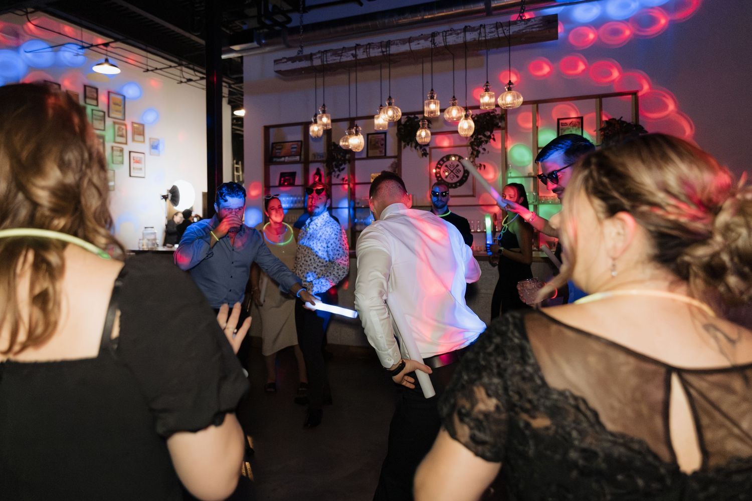 guests dance during party reception at Tire Shack Brewery night time flash photography