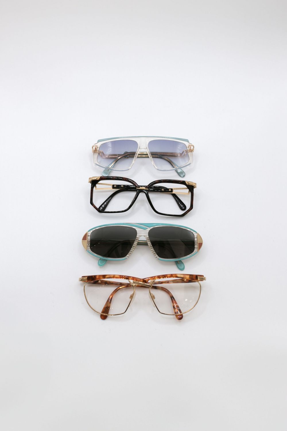 Collection of vintage and modern sunglasses in different styles displayed on white background.