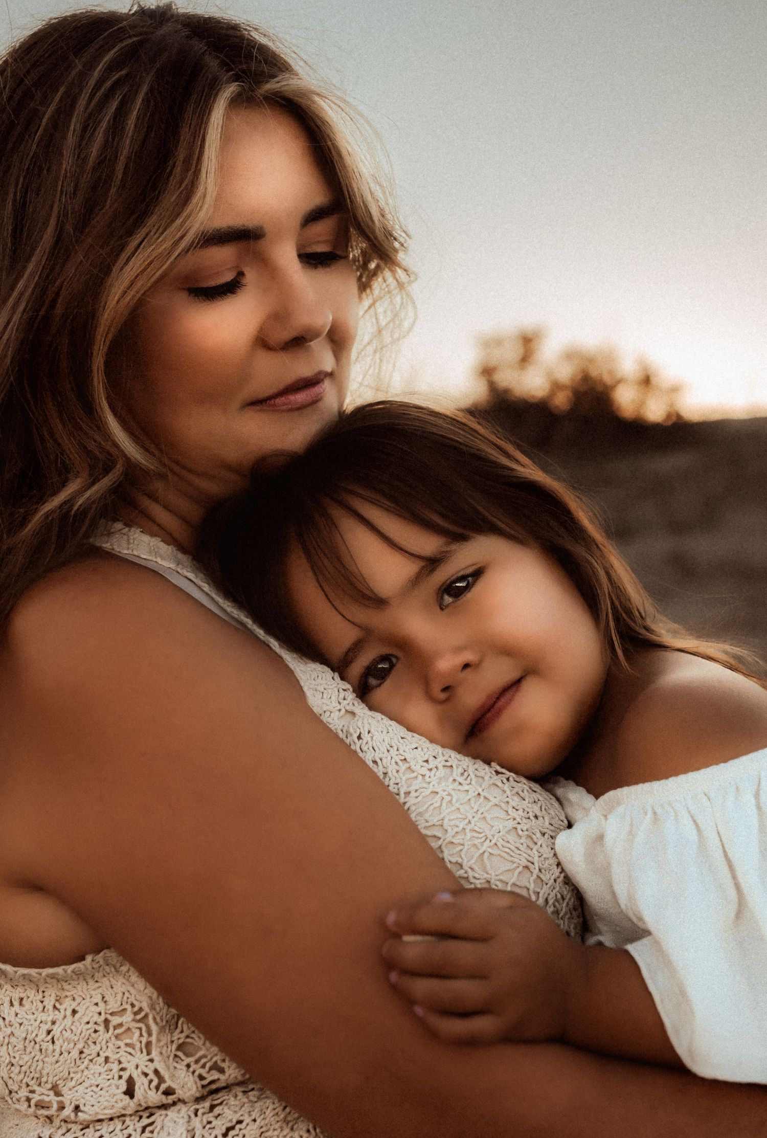 mom and daughter in Javea  share a tender moment embracing at sunset. Javea photographer
