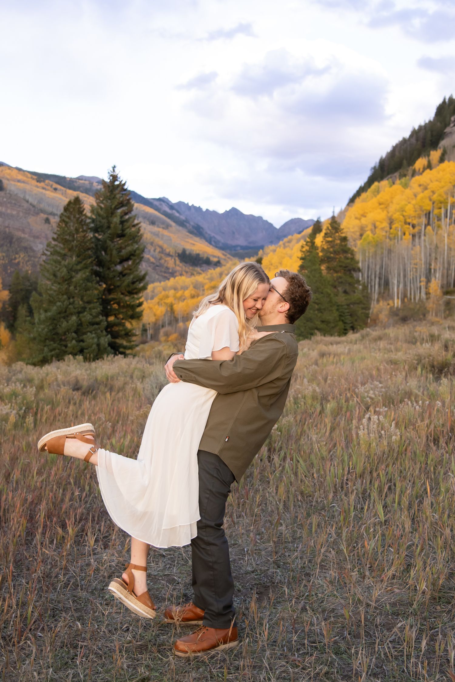 Vail fall engagement photos with cute couple in the aspen leaves and mountains