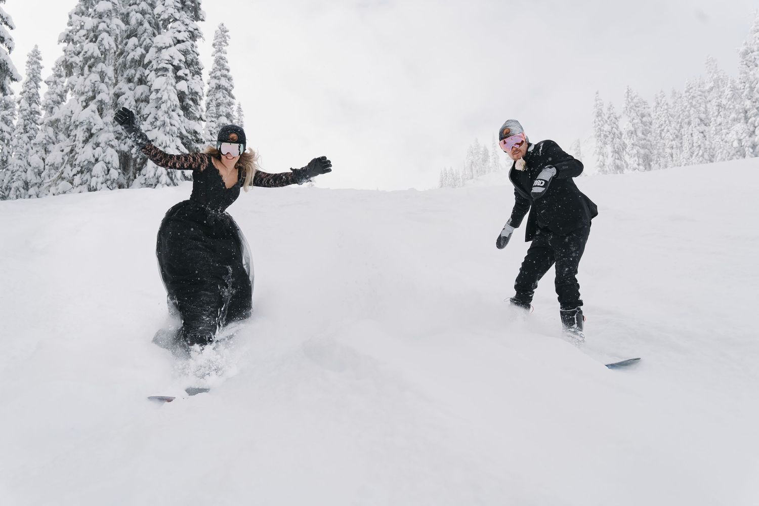 A group of snowboarders enjoying fresh powder on a snowy mountain slope during winter.