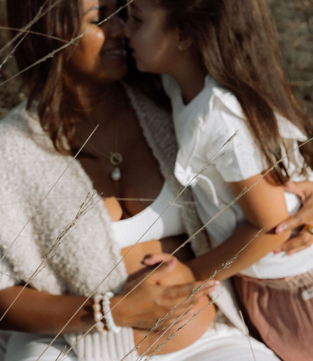 Artistic maternity portraits with delicate lighting and natural elements.