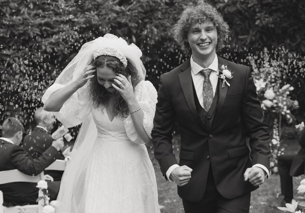 Black and white wedding portraits showing joyful candid moments outdoors.