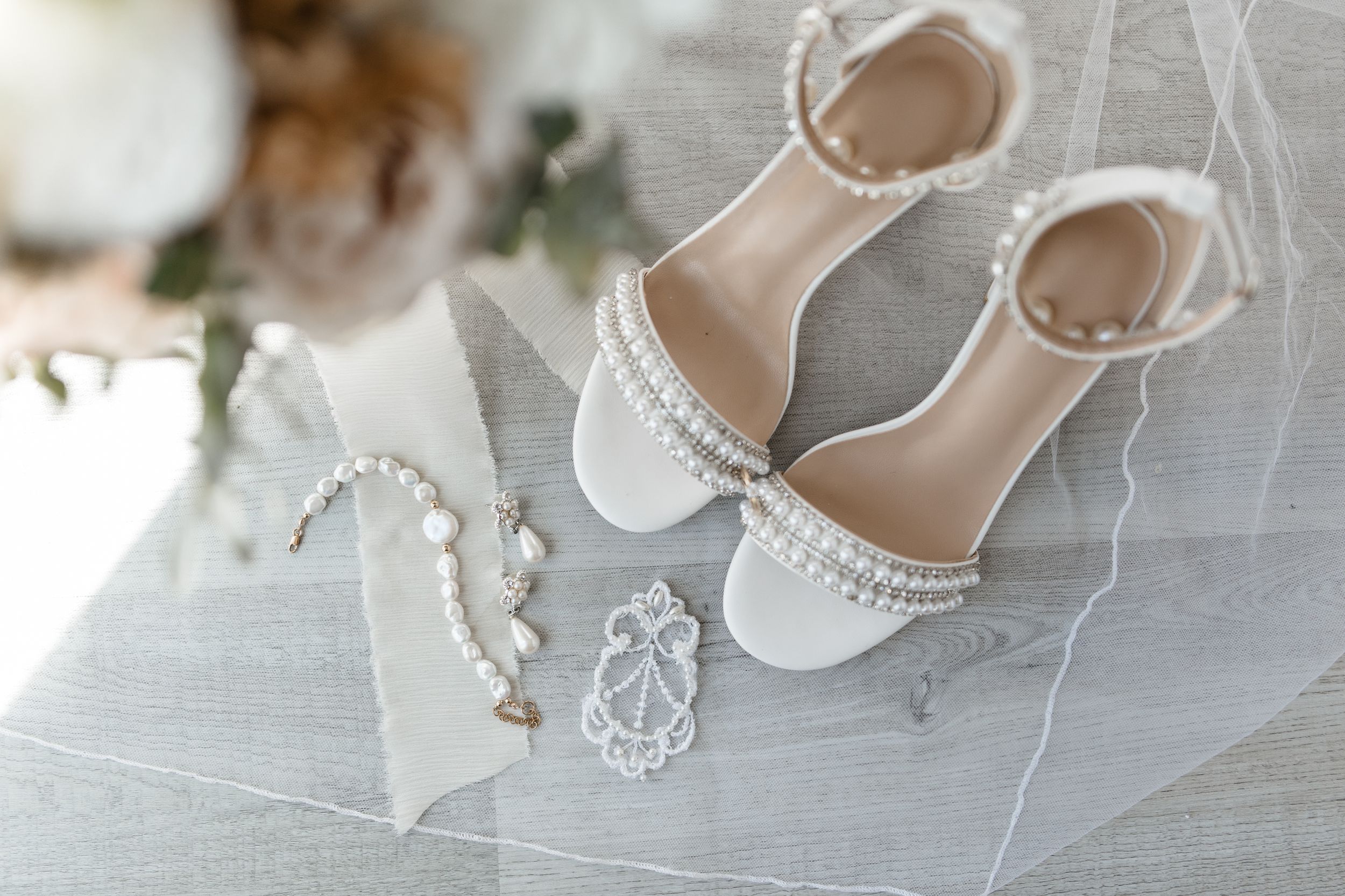 A series of five close-up photos showing a delicate white pearl necklace with lace details and jewelry.