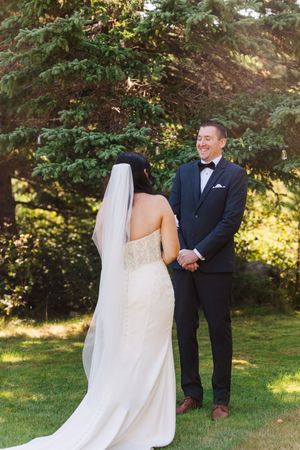 A wedding first look sequence showing a bride surprising her groom in a garden setting with natural sunlight.
