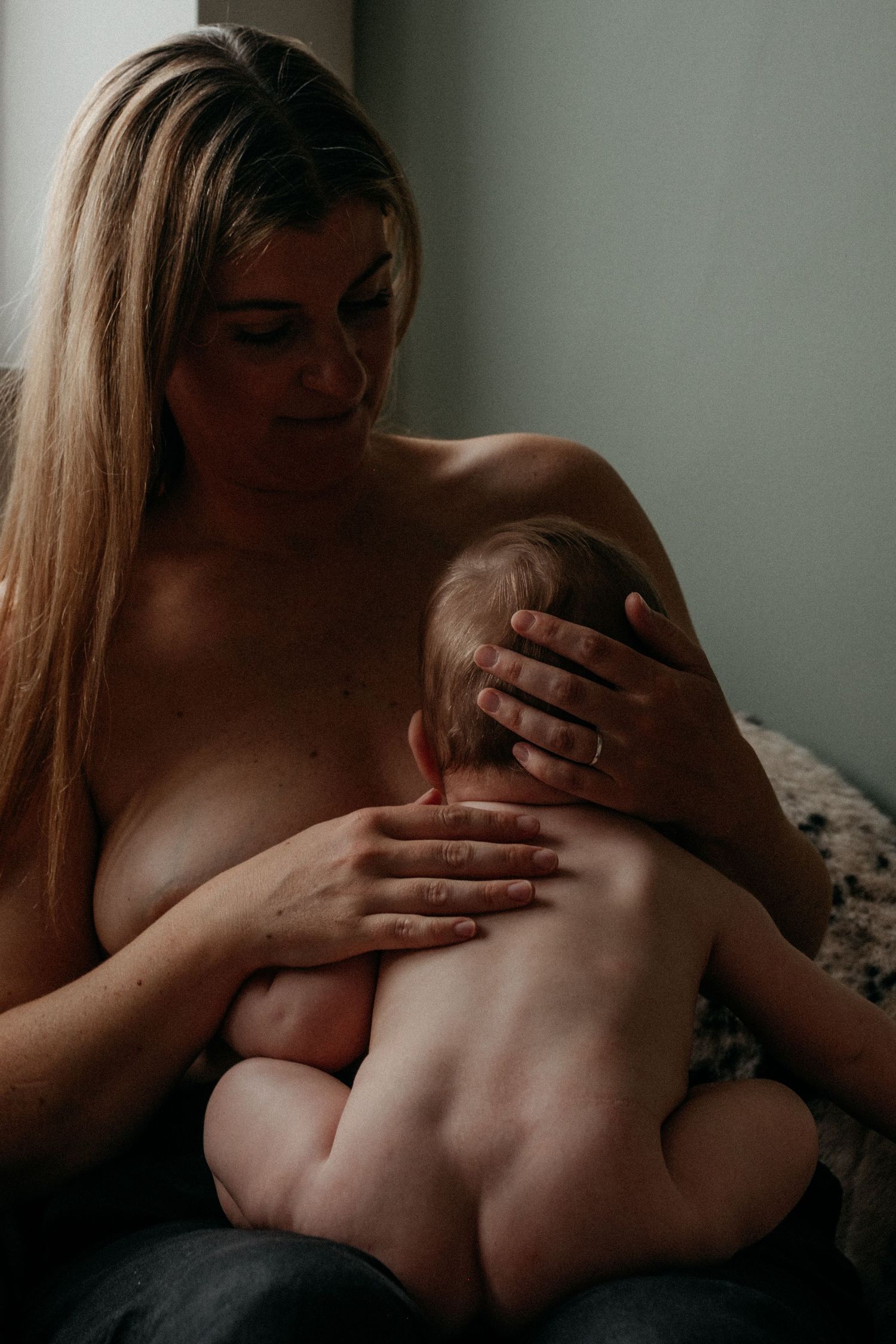 Quiet breastfeeding moment captured during a relaxed motherhood photography session, showing the closeness and connection between mother and