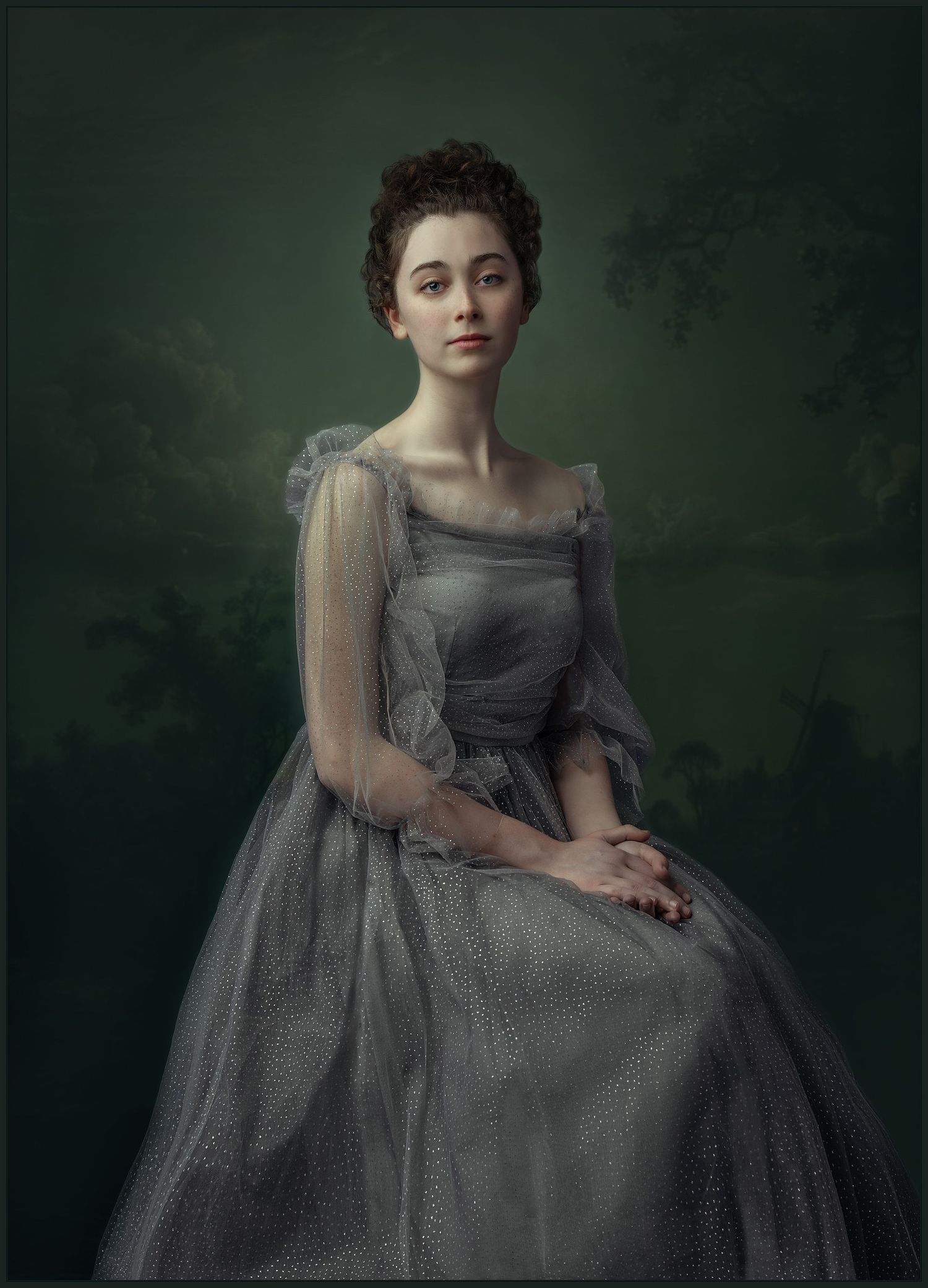 Elegant woman in a gray tulle gown posed in a classical portrait style against a dark green background.