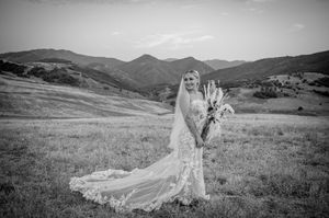 Scenic mountain landscape with flowing white dress fabric captured in dramatic black and white photography.