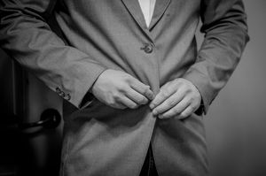 Detail shot of formal suit jackets in classic black and white photography.