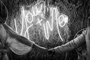 Black and white neon light wedding sign display creating a romantic ambiance.