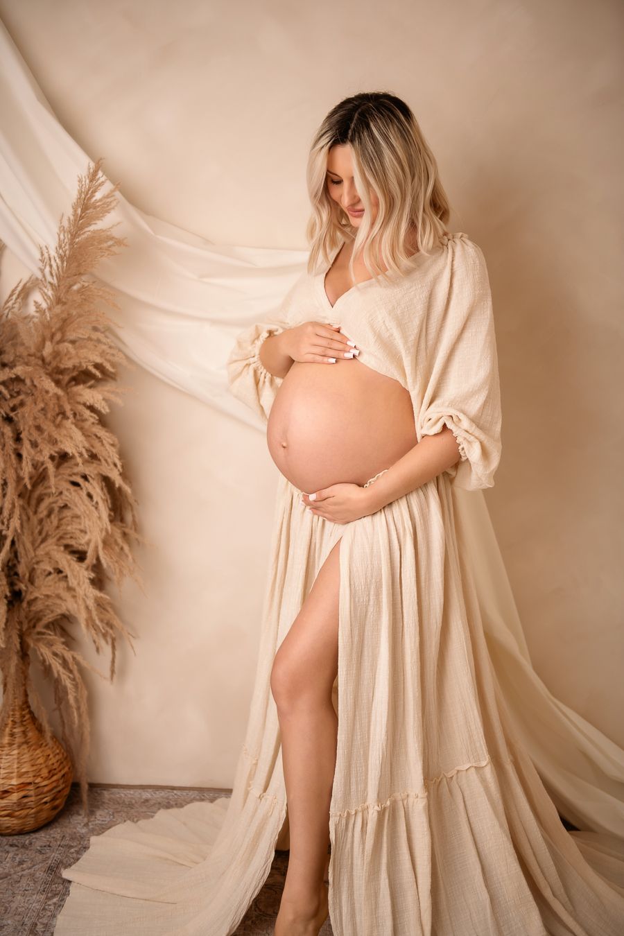 Maternity photo series showing a pregnant mum gently caressing her pregnancy bump.