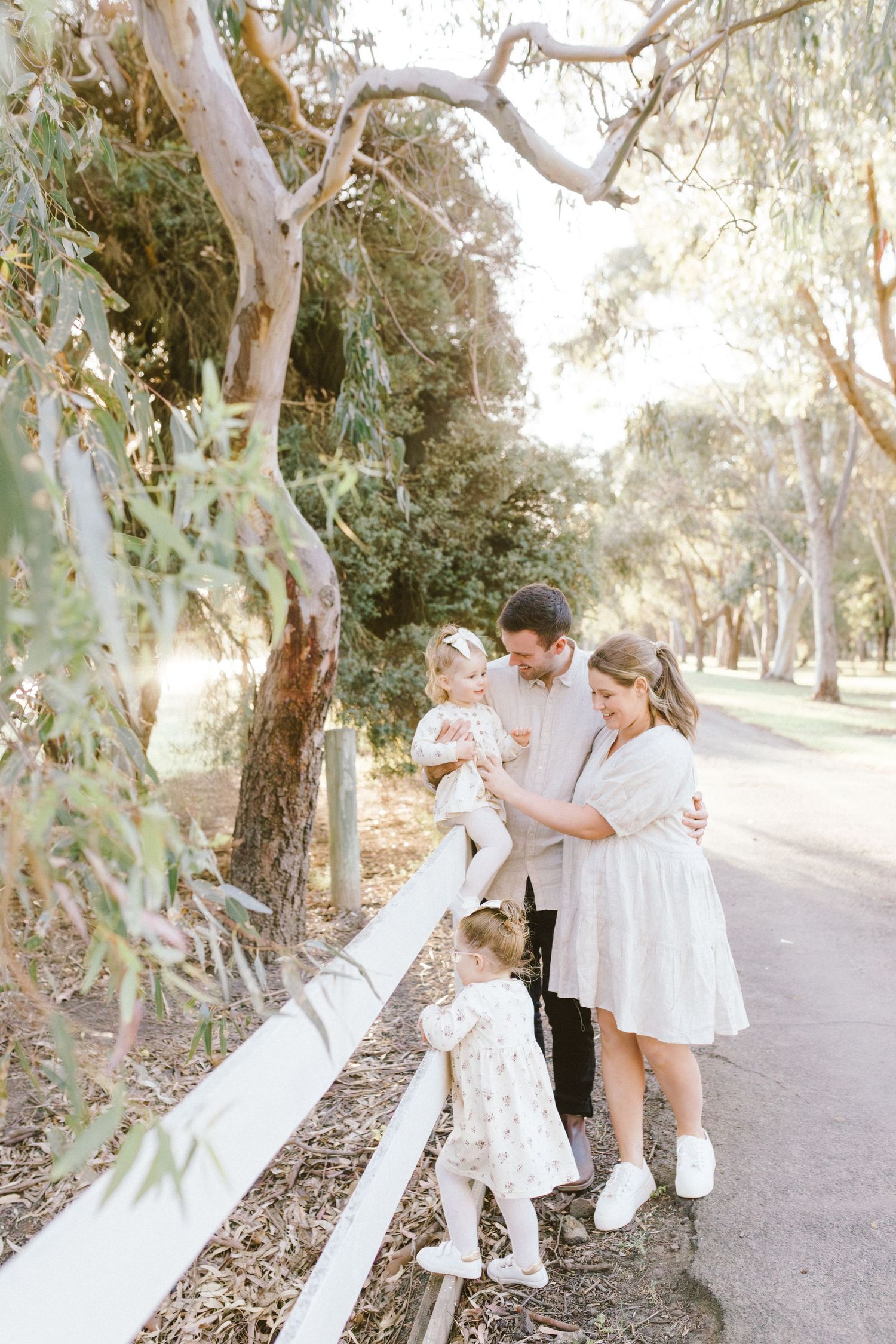 Natural candid moments of a family walking and playing together on a eucalyptus-lined trail.