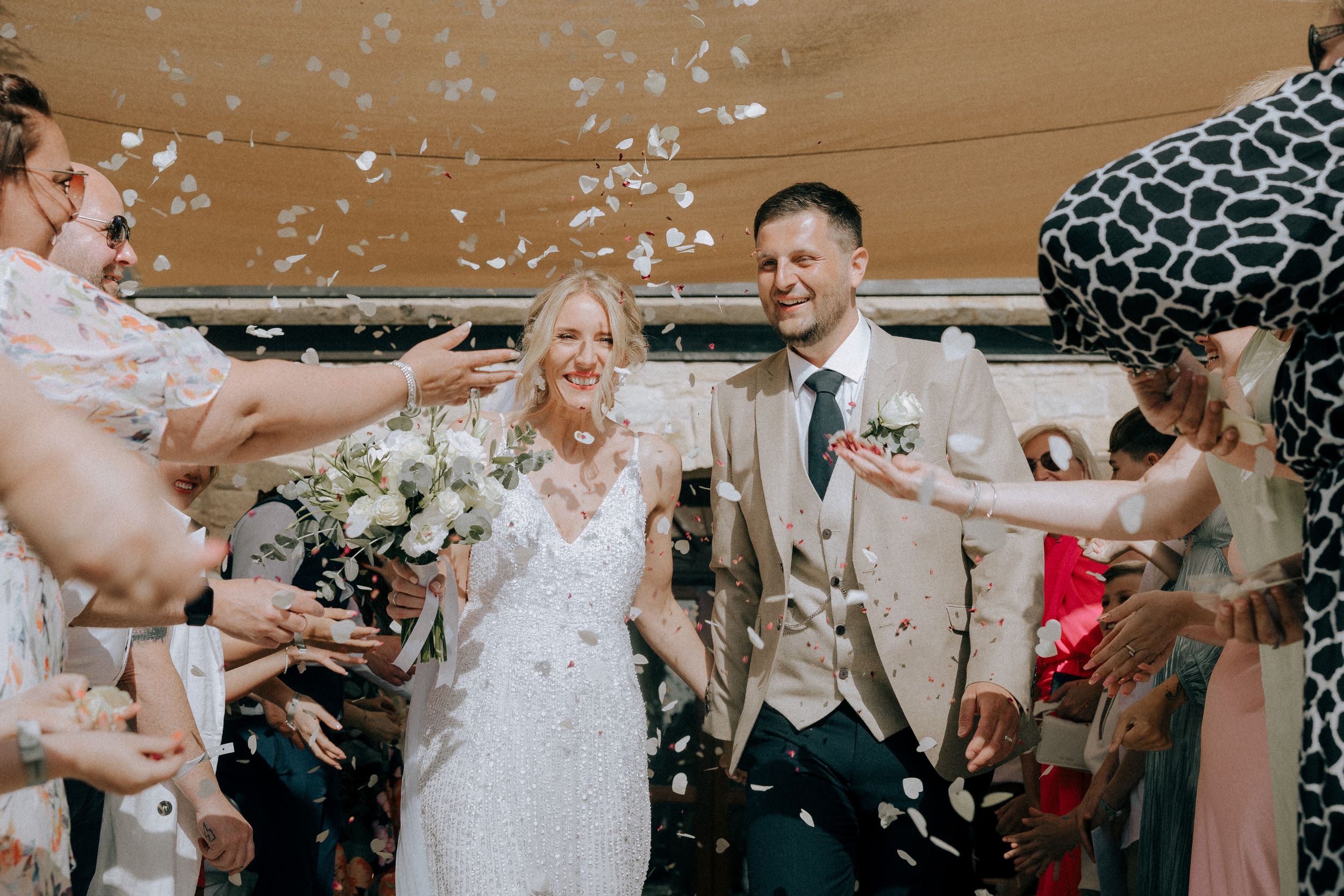 Confetti falls during a joyous wedding celebration. Cyprus wedding photographers. Candid moments, natural poses. Engagement shoot Paphos