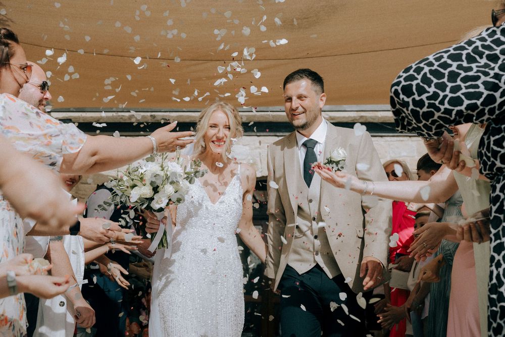 Confetti falls during a joyous wedding celebration. Cyprus wedding photographers. Candid moments, natural poses. Engagement shoot Paphos